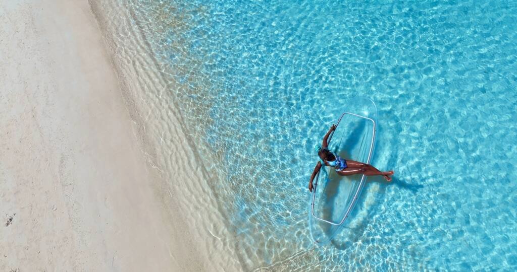Drone shot: clear kayak next to the beach shoreline in Aruba