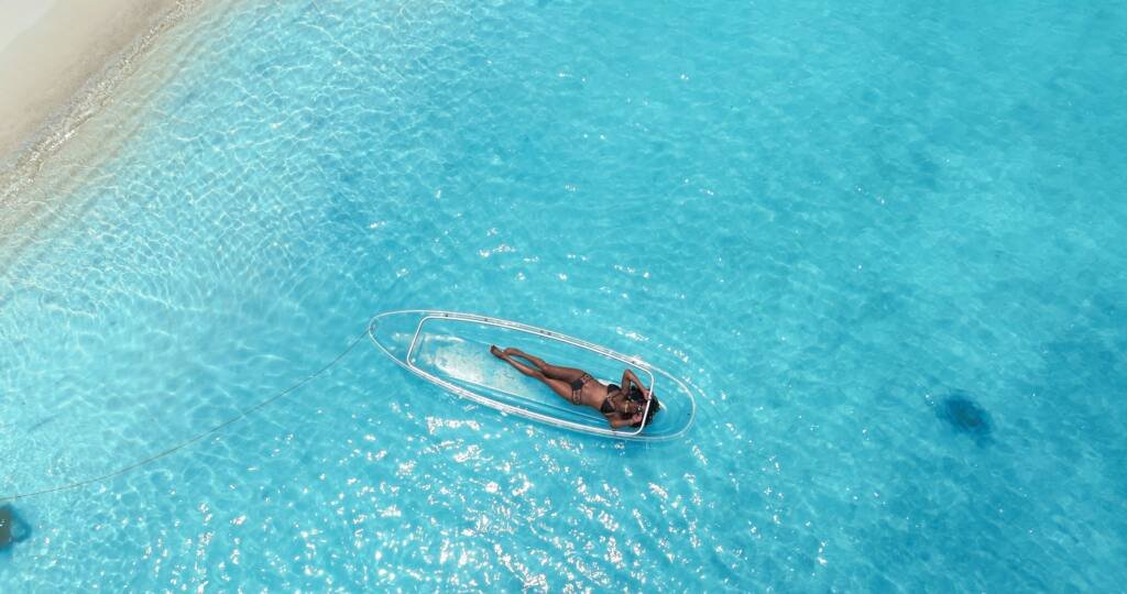Drone shot: clear kayak drifting near the beach in Aruba