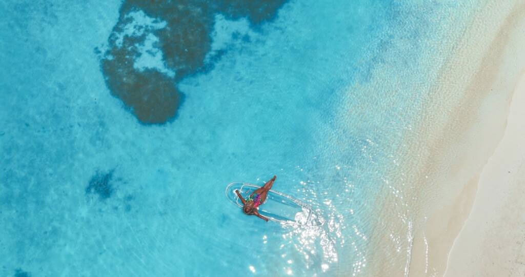 Drone shot: clear kayak above a reef close to the beach in Aruba